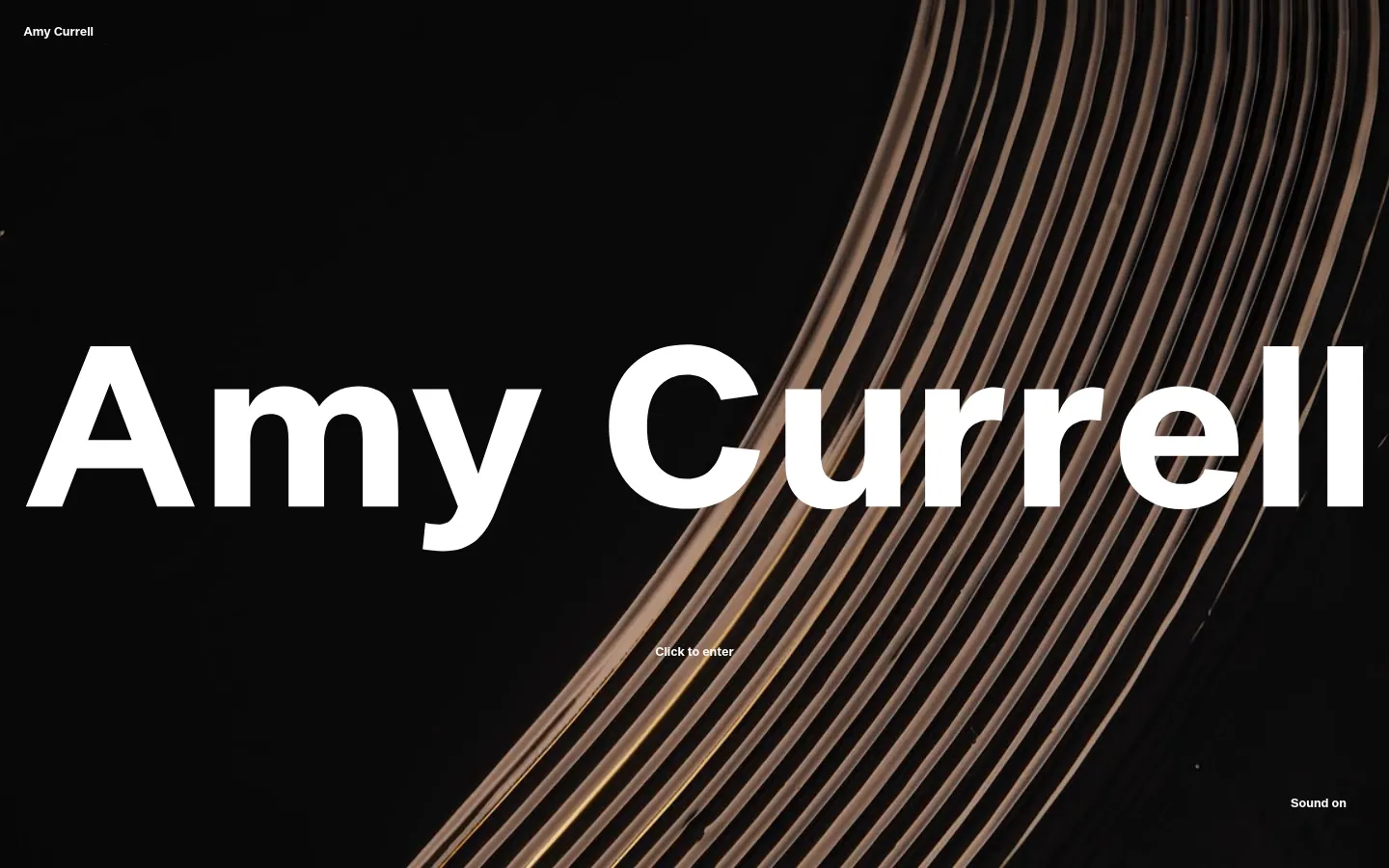 The desktop homepage features a large, high-contrast hero image with dark tones and golden, curved architectural lines. The name 'Amy Currell' is displayed in massive white sans-serif typography centered on the screen, with small 'Click to enter' and 'Sound on' text links positioned below and in the corner.