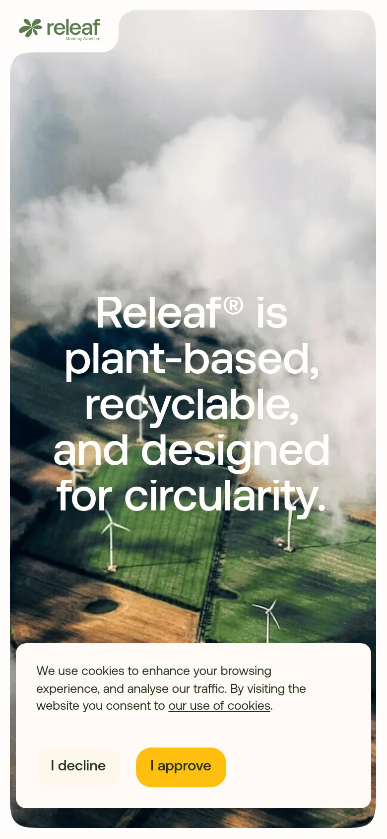 The mobile version shows a vertically oriented version of the aerial landscape with wind turbines and clouds. The headline is centered and stacked in large white text, and the cookie consent banner is expanded into a large white card at the bottom of the screen.