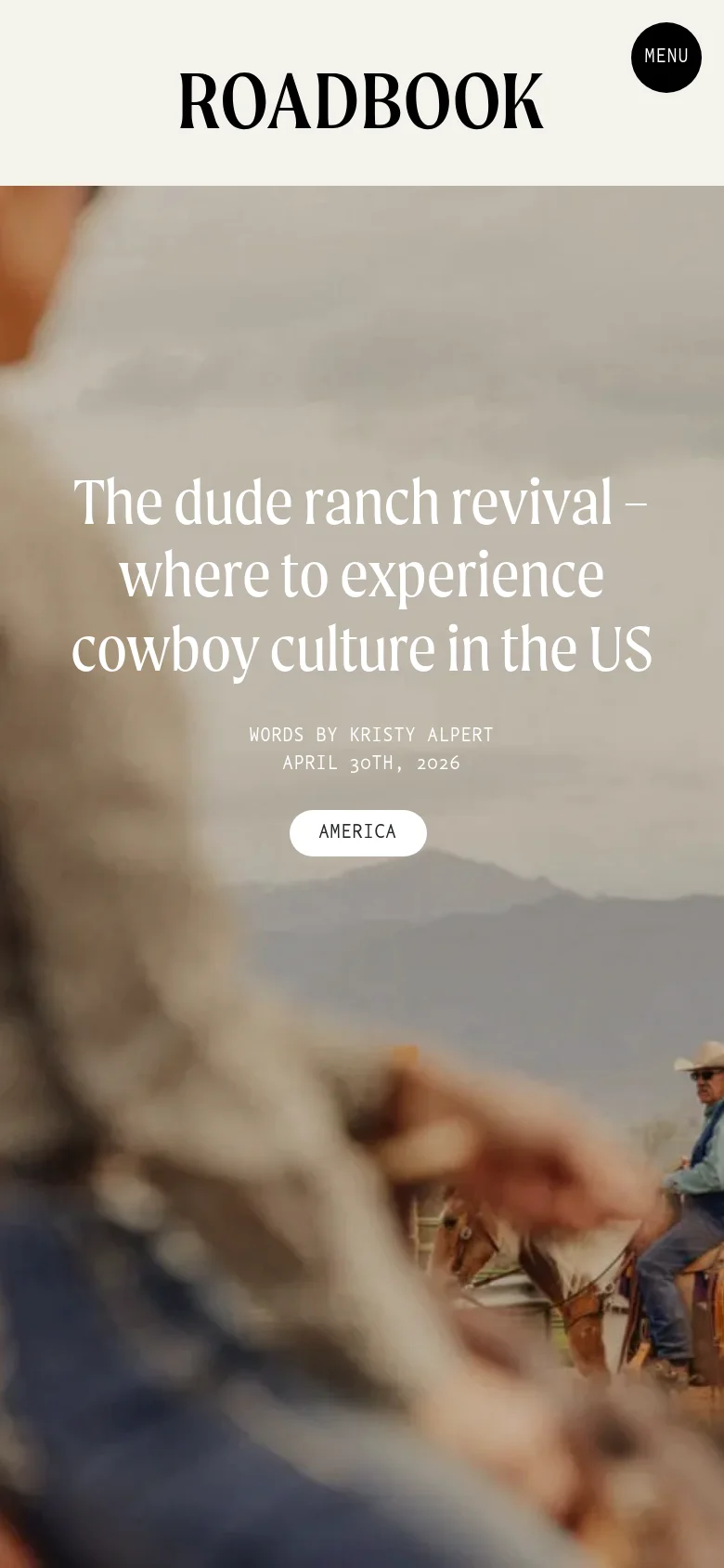 The mobile version presents a vertically stacked layout where the hero image fills the background behind white text. The headline 'The dude ranch revival – where to experience cowboy culture in the US' is centered over the image, followed by the author, date, and an 'AMERICA' tag button. The 'ROADBOOK' logo and circular 'MENU' button remain at the top of the screen.