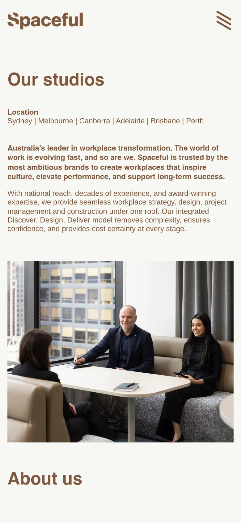 The mobile version displays a simplified layout with a large Spaceful logo and a hamburger menu icon in the top right. The 'Our studios' headline and location list are stacked vertically, and the hero section is followed by a large, full-width photograph of two professionals sitting at a table in a modern office setting before the 'About us' section.