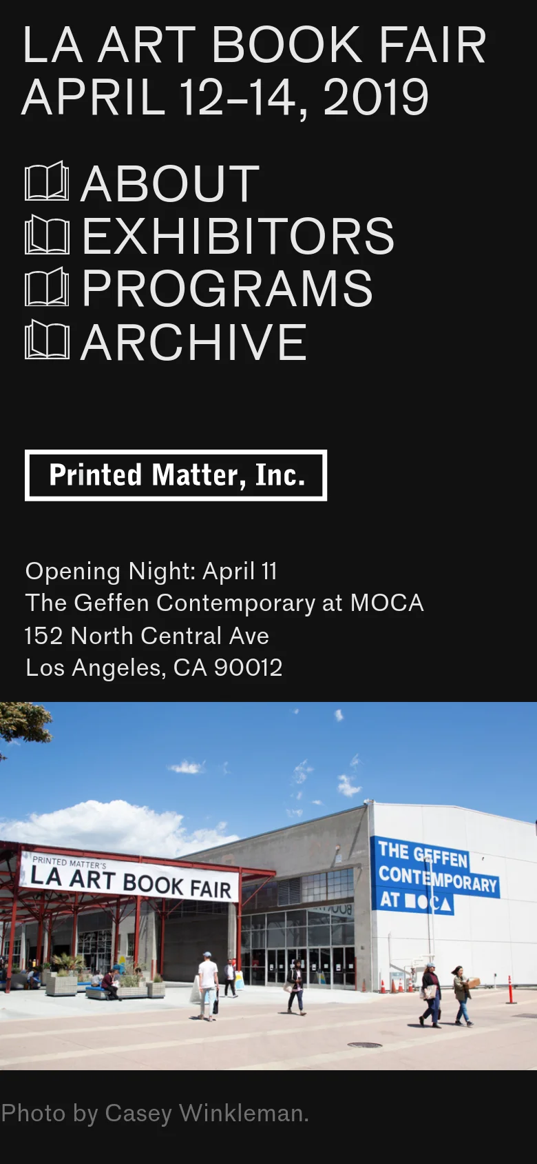 The mobile version uses a stacked layout on a dark background, placing the large 'LA ART BOOK FAIR' headline and navigation menu at the top. The 'Printed Matter, Inc.' button and event location details are centered above a full-width photograph of the venue. The layout is simplified into a single vertical column for easier scrolling on small screens.