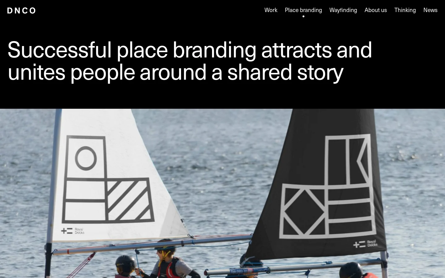 The desktop page features a dark header with the DNCO logo and navigation links. A large white headline, 'Successful place branding attracts and unites people around a shared story,' sits above a wide hero image of sailboats on the water with graphic patterns on their sails. The layout is spacious with a black background in the hero section and white background for the content below.