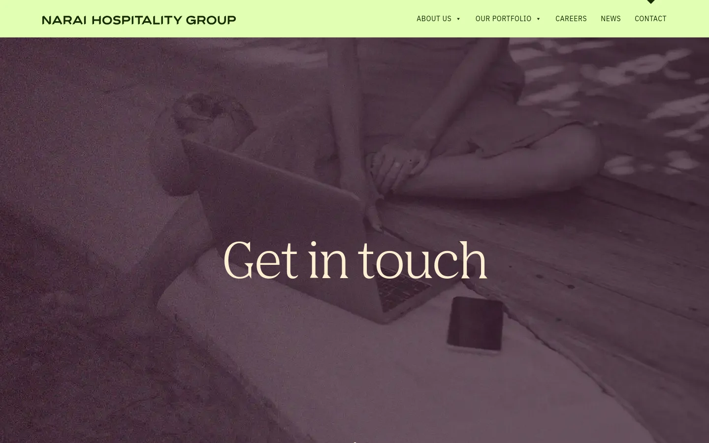 The desktop contact page features a light green navigation bar with the Narai Hospitality Group logo and menu links. A large hero section shows a muted, dark purple-toned image of a person using a laptop on a beach with the headline 'Get in touch' centered in white serif text.