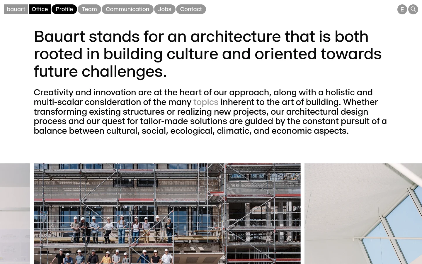 The desktop page features a minimalist white layout with a top navigation bar containing links like Office and Profile. A large, bold headline dominates the upper section, followed by a descriptive paragraph and a wide, high-quality architectural photograph showing a building under construction with scaffolding and workers. The design uses clean typography and ample white space to create a professional aesthetic.