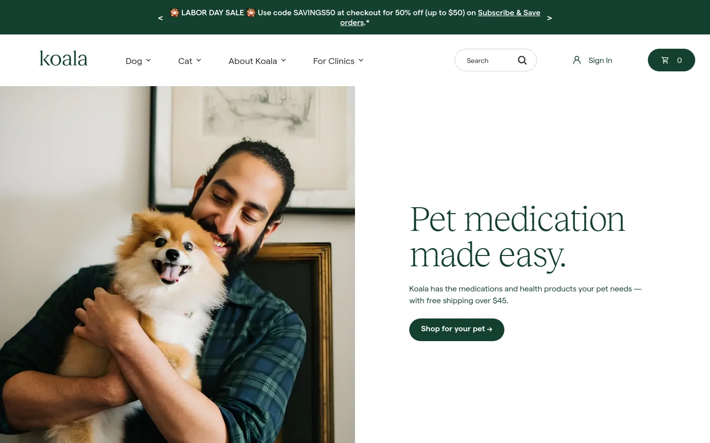 The desktop homepage features a hero section with a large photo of a smiling man hugging a small fluffy dog on the left, and the headline 'Pet medication made easy' with a 'Shop for your pet' call-to-action button on the right. A green announcement bar at the top promotes a Labor Day sale. The navigation menu includes links for Dog, Cat, About Koala, and For Clinics, alongside a search bar and shopping cart.