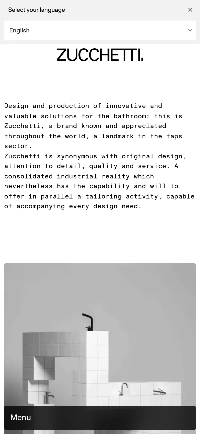 The mobile version presents a vertically stacked layout with the brand introduction text at the top. Below the text, a large grayscale image of bathroom faucets on tiled structures fills the width of the screen. A dark 'Menu' bar is anchored at the bottom of the viewport, and a language selection dropdown is visible at the top.
