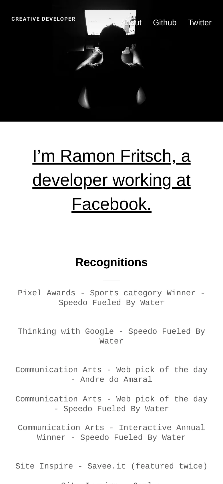 The mobile version maintains the dark theme and minimalist layout, but the navigation links are condensed and the hero image is cropped to focus on the silhouette. The large, underlined headline and the list of recognitions are stacked vertically for easier scrolling on a smaller screen.