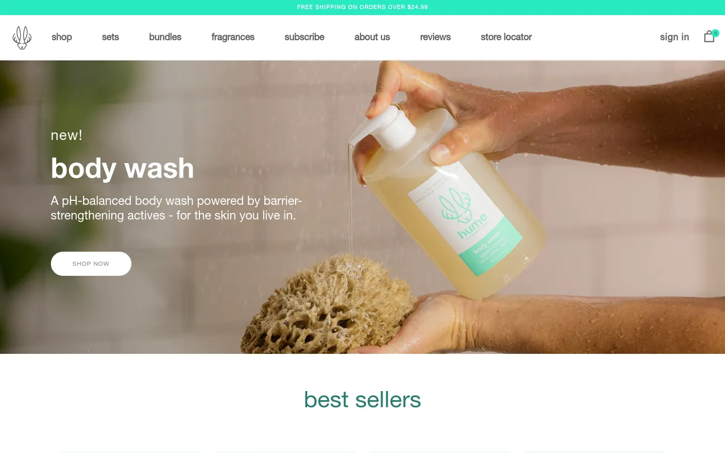 The desktop homepage features a clean, minimalist design with a white navigation bar and a large hero image of hands using a liquid body wash with a natural sponge. A prominent headline reads 'new! body wash' with a 'SHOP NOW' call to action button over a warm, earthy-toned background. Below the hero section, a 'best sellers' grid displays various product images and prices against a white background.