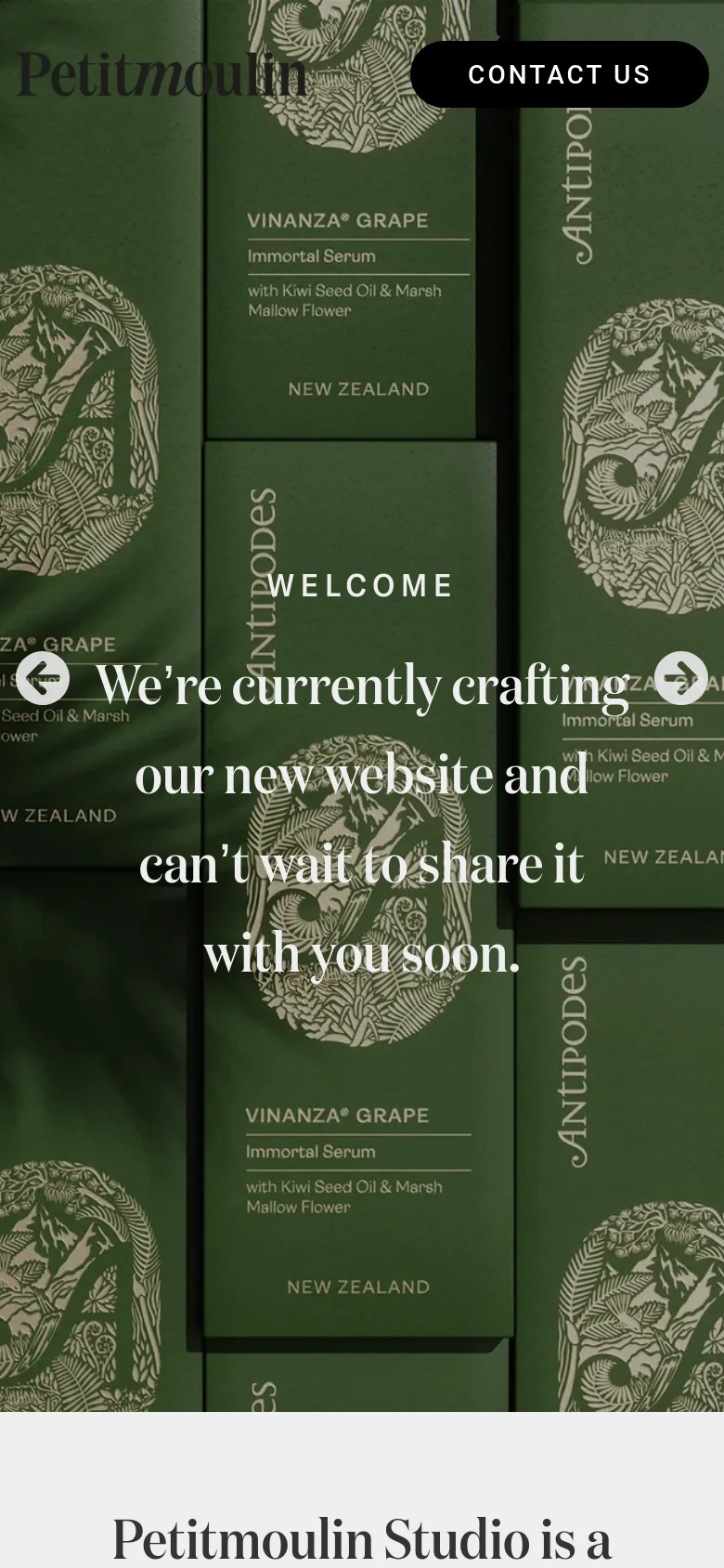 The mobile version maintains the same aesthetic but uses a vertical layout, centering the large white serif announcement text over a close-up view of the amber skincare bottles. The 'CONTACT US' button is positioned at the top, and the background imagery is tightly cropped to fit the narrow screen.
