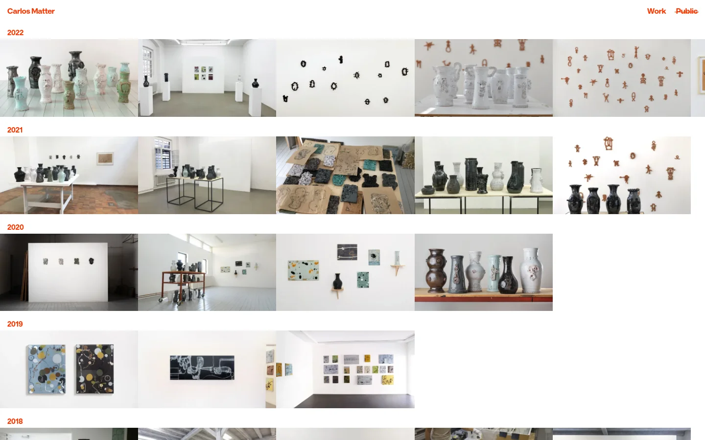 A minimalist artist portfolio website featuring a white background and red accents. The layout displays a chronological grid of large artwork photographs organized by year, such as 2022 and 2021, showcasing various ceramic sculptures and installation views. Navigation links for 'Work' and 'Public' are located at the top right.