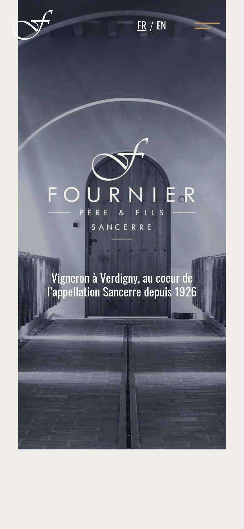 The mobile version presents a vertically oriented, grayscale hero image of the wine cellar, maintaining the central logo and headline. The layout is simplified for a smaller screen, with the logo, language options, and a hamburger menu icon condensed at the top.