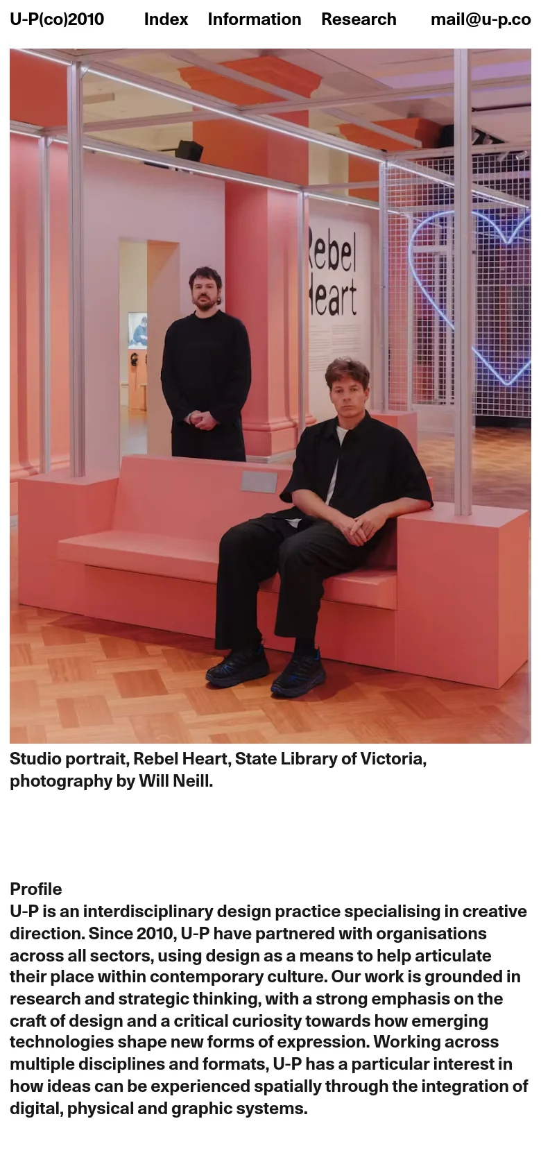 The mobile version simplifies the layout into a single vertical column, starting with the large studio portrait hero image. The text-heavy profile section and news articles are stacked vertically for easy scrolling, and the navigation menu is condensed at the top.