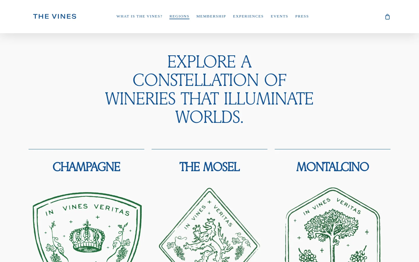 The desktop page features a clean, minimalist layout with a white background and navy blue serif typography. A large hero headline reads 'EXPLORE A CONSTELLATION OF WINERIES THAT ILLUMINATE WORLDS,' followed by a grid of wine regions including Champagne, The Mosel, and Montalcino, each accompanied by a green line-art emblem and descriptive text.