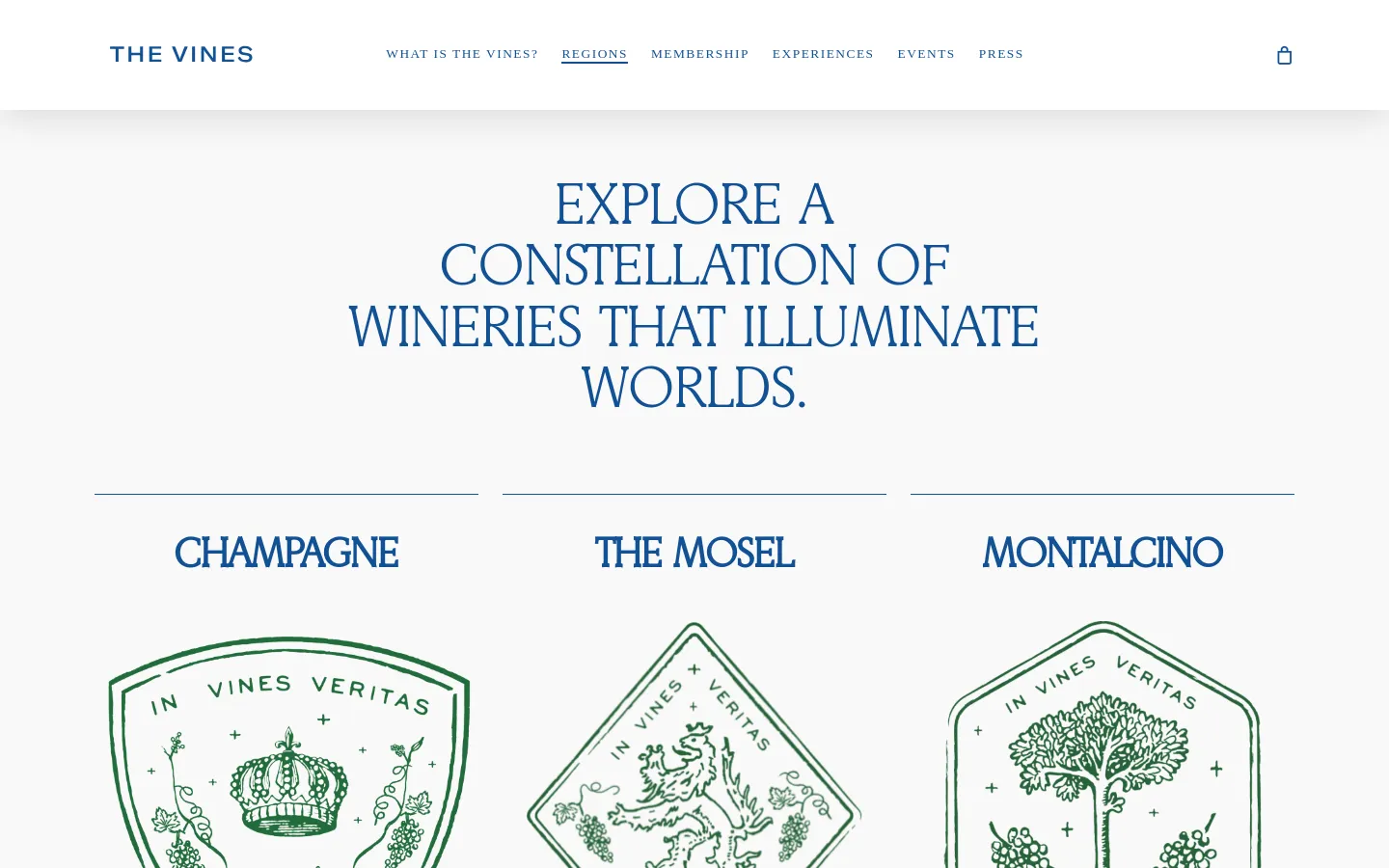 The desktop page features a clean, minimalist layout with a white background and navy blue serif typography. A large hero headline reads 'EXPLORE A CONSTELLATION OF WINERIES THAT ILLUMINATE WORLDS,' followed by a grid of wine regions including Champagne, The Mosel, and Montalcino, each accompanied by a green line-art emblem and descriptive text.