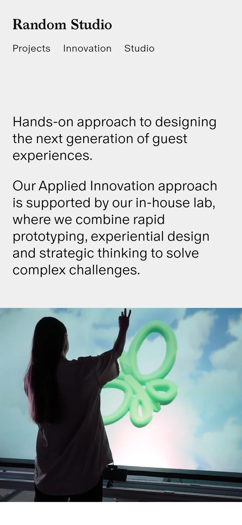 The mobile version maintains the same minimalist aesthetic and content but uses a stacked layout. The 'Random Studio' logo is centered at the top above a simplified navigation menu, and the text is left-aligned with larger line spacing for readability on a smaller screen.