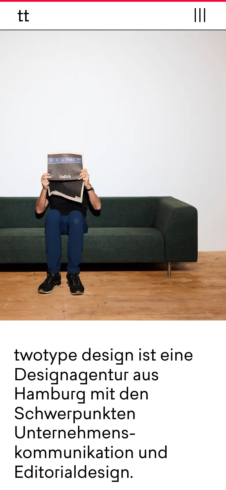 The mobile version features a simplified header with the 'tt' logo and a hamburger menu icon on the right. Below the header, a large headline introduces the design agency, followed by a hero image of a person sitting on a dark green sofa holding a newspaper over their face. The layout is vertically stacked for easy scrolling on small screens.