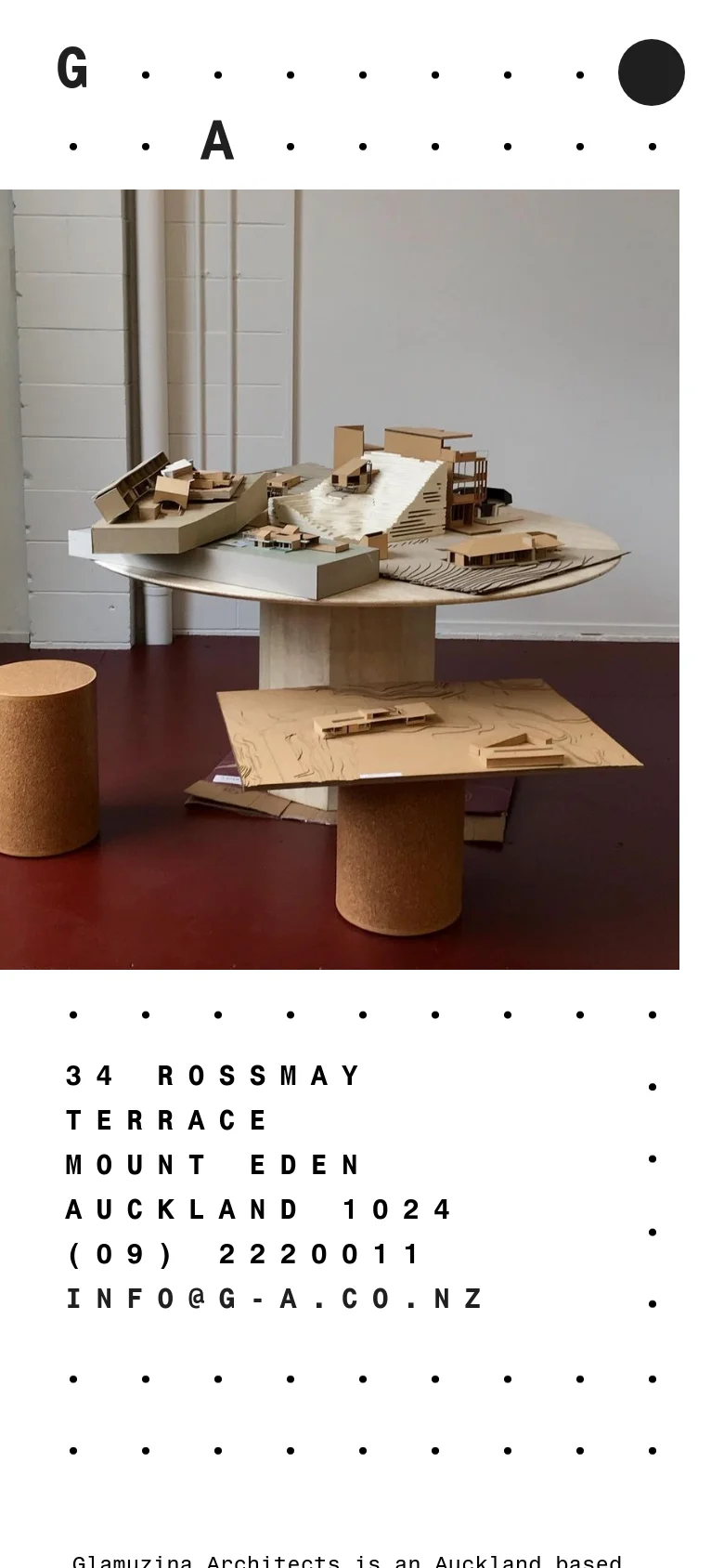 The mobile version transitions to a single-column vertical layout, placing the large architectural model image at the top. The text and contact details follow below in a simplified, stacked format, maintaining the minimalist aesthetic and black-on-white color scheme.