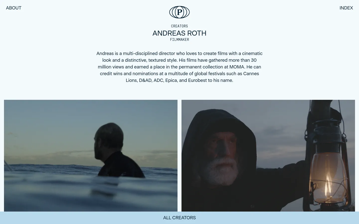 The desktop page features a minimalist white background with a centered logo and navigation links for 'ABOUT' and 'INDEX'. A large heading introduces filmmaker Andreas Roth, followed by a biographical paragraph and a wide cinematic hero image split into two panels showing a man in the sea and a close-up of a bearded man holding a lantern. A light blue footer contains the 'ALL CREATORS' call to action.