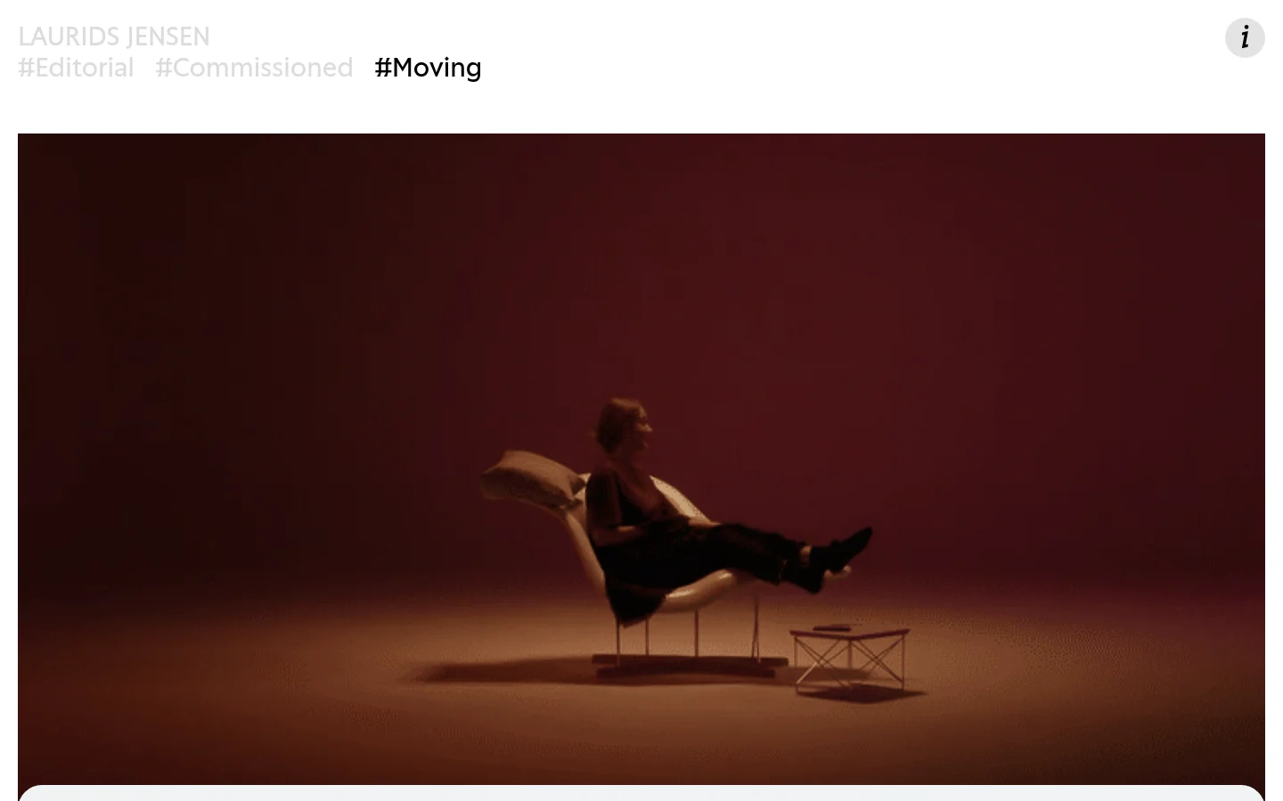 The desktop page features a minimalist white header with the name 'LAURIDS JENSEN' and navigation links for Editorial, Commissioned, and Moving. Below the header, a large video player displays a cinematic shot of a person sitting in a chair against a deep reddish-brown background. The layout is clean with significant whitespace and dark, moody visual content.