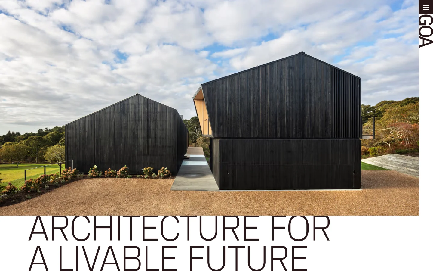 The desktop homepage features a minimalist design with a large hero image of a modern black wooden building under a cloudy sky. The headline 'ARCHITECTURE FOR A LIVABLE FUTURE' is displayed in large, thin black capital letters at the bottom, with the 'GOA' logo positioned vertically on the right side.