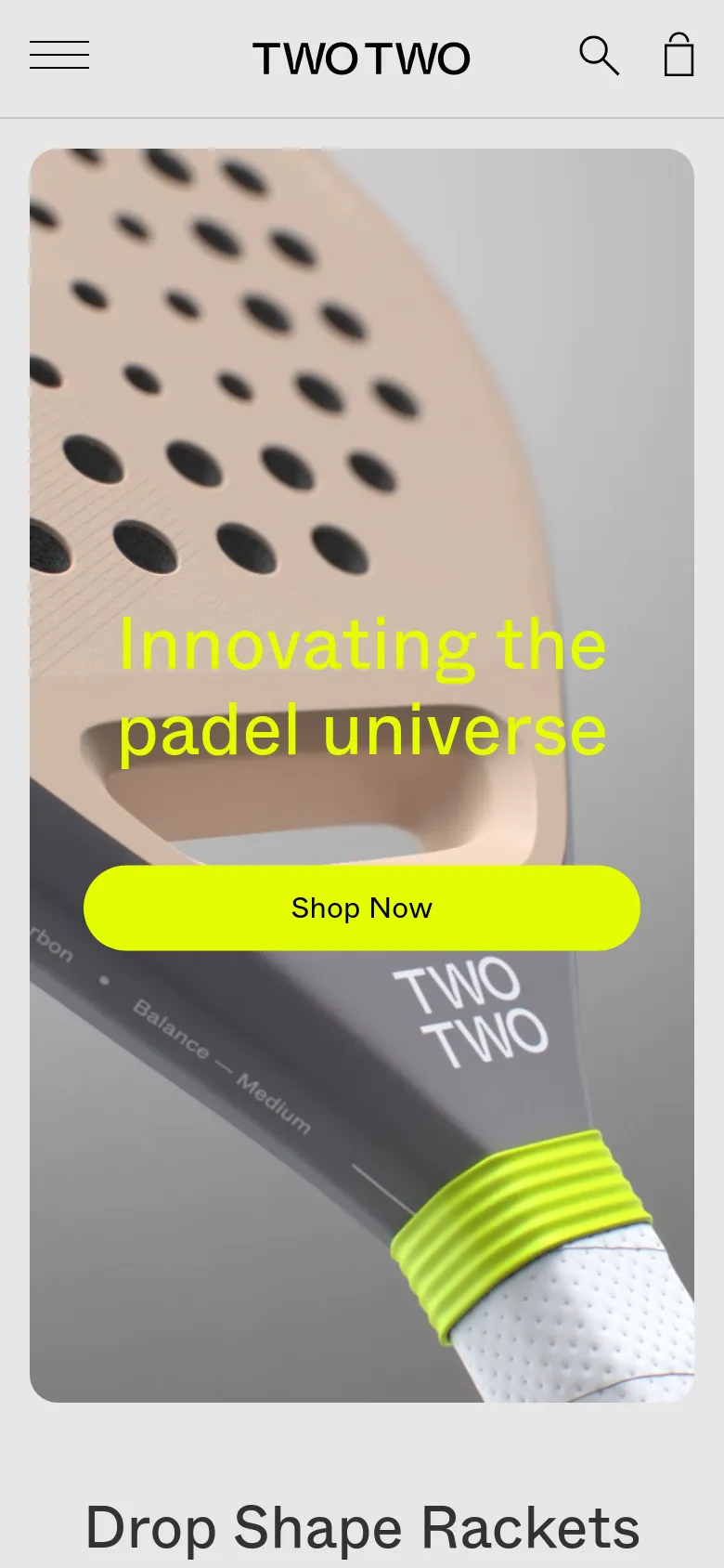 The mobile version presents a vertically oriented hero section with the same close-up racket imagery and yellow 'Innovating the padel universe' headline and 'Shop Now' button. The top navigation is condensed into a hamburger menu icon on the left, with the TWOTWO logo centered and search and shopping bag icons on the right. The content scales to fit a narrow screen, prioritizing the central call to action.