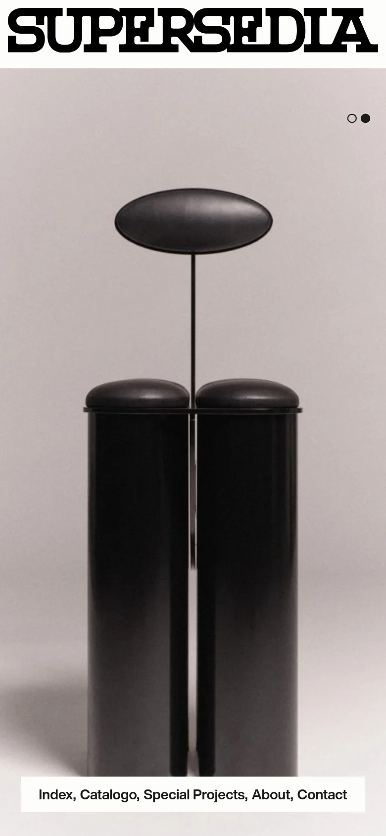 The mobile version presents a vertically stacked layout with the large 'SUPERSEDIA' logo at the top. The navigation menu is positioned below the logo, and the hero image of a black sculptural object occupies the central portion of the screen, maintaining the minimalist aesthetic and pagination dots.