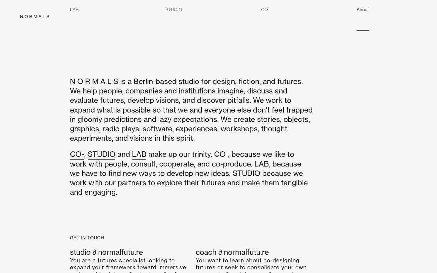 The About page features a minimalist, high-contrast design with black text on a light grey background. The layout consists of a top navigation bar with links for LAB, STUDIO, CO., and About, followed by large-scale typography explaining the studio's mission and its three pillars: CO-, STUDIO, and LAB. Contact information and partner logos are organized in a clean, spacious vertical flow.