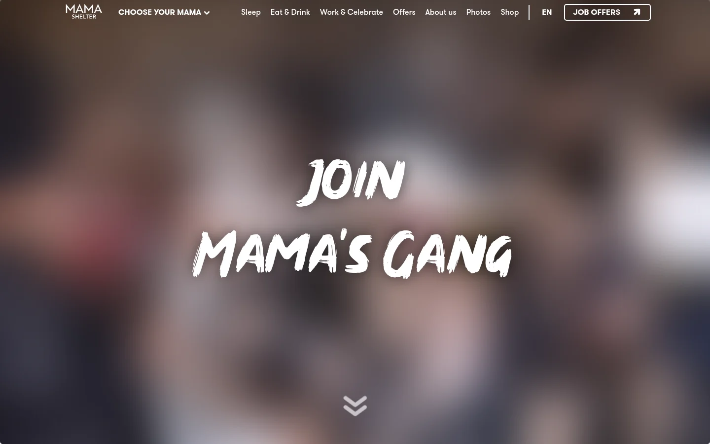 The desktop landing page features a large, blurred background image of a diverse, smiling group of people. Centered in large, white, stylized brushstroke typography is the headline 'JOIN MAMA'S GANG', with a downward arrow icon below it. A top navigation bar includes the Mama Shelter logo, various menu links, and a prominent 'JOB OFFERS' button with an arrow icon.
