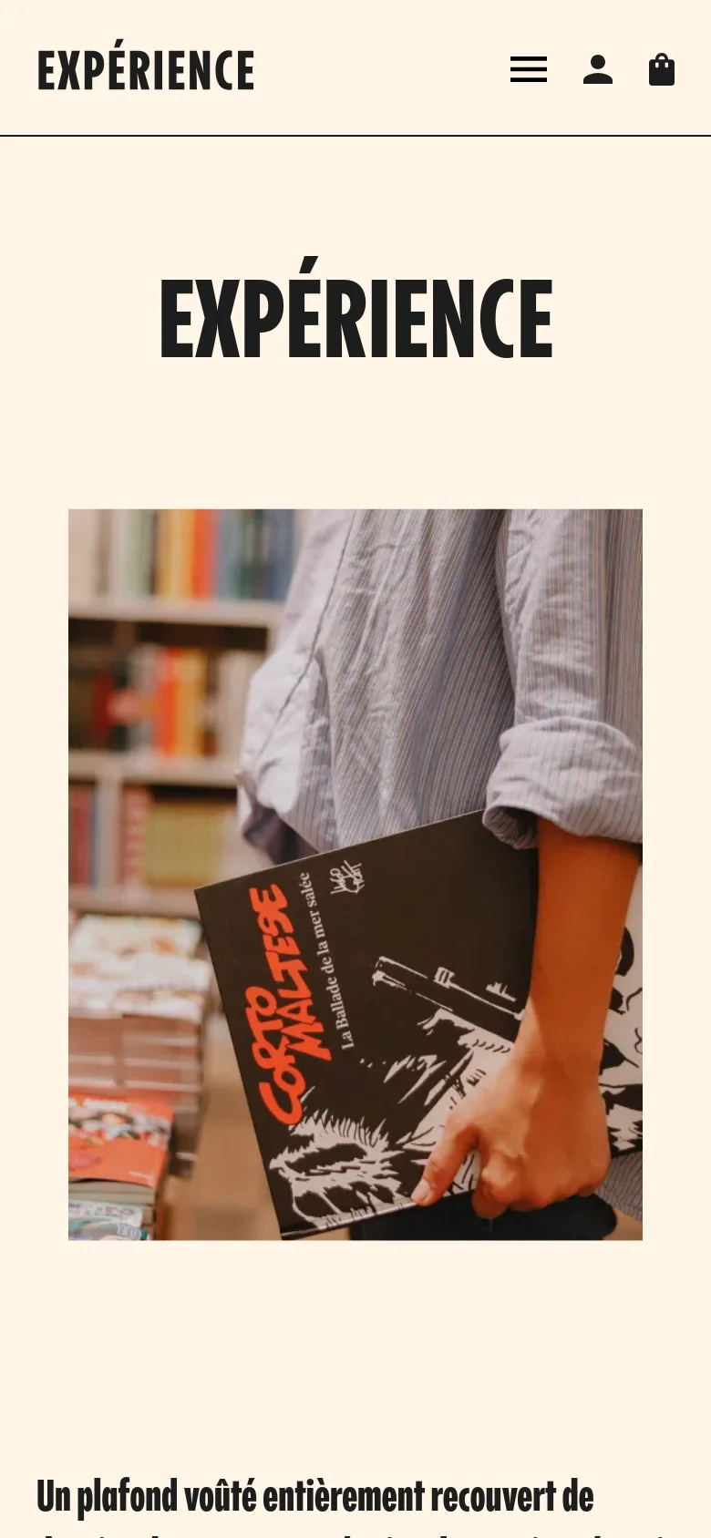 The mobile version maintains the cream background and bold black typography but shifts to a single-column layout. The header is condensed into a white bar containing a hamburger menu, a user icon, and a shopping bag icon, while the large 'EXPÉRIENCE' title and hero image of a person holding a comic book are stacked vertically.