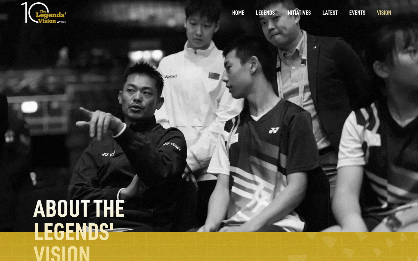 The desktop page features a large black and white hero image of badminton players with the headline 'ABOUT THE LEGENDS' VISION' in bold white text. A navigation menu is at the top right, and the layout uses a gold and white color scheme with sections for history, statistics, and a timeline. The design is spacious with large typography and high-contrast imagery.