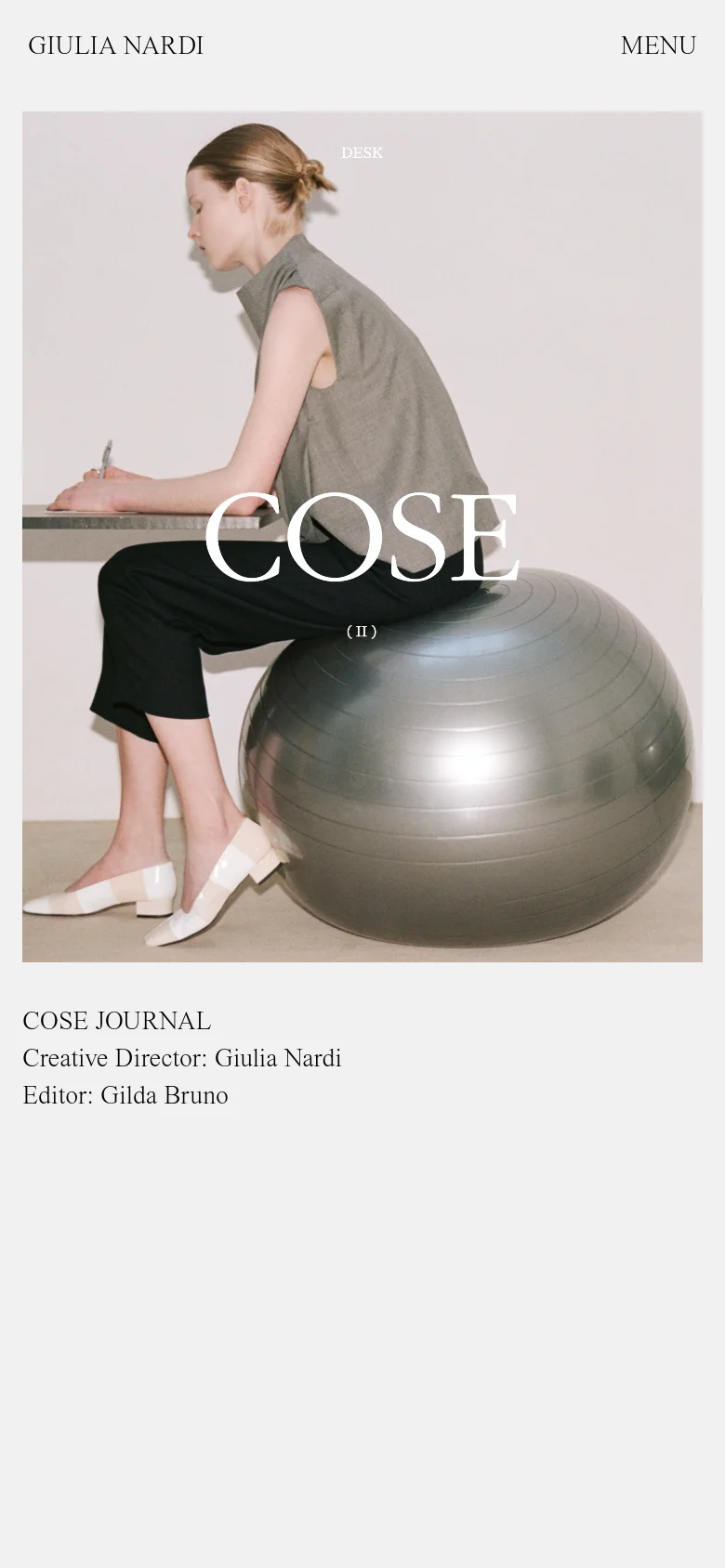 The mobile version presents a single-column vertical scroll optimized for small screens. The hero image of the woman at the desk dominates the top of the viewport, followed by the journal title and editorial credits in a clean, centered layout. The navigation is condensed into a 'MENU' button at the top right.