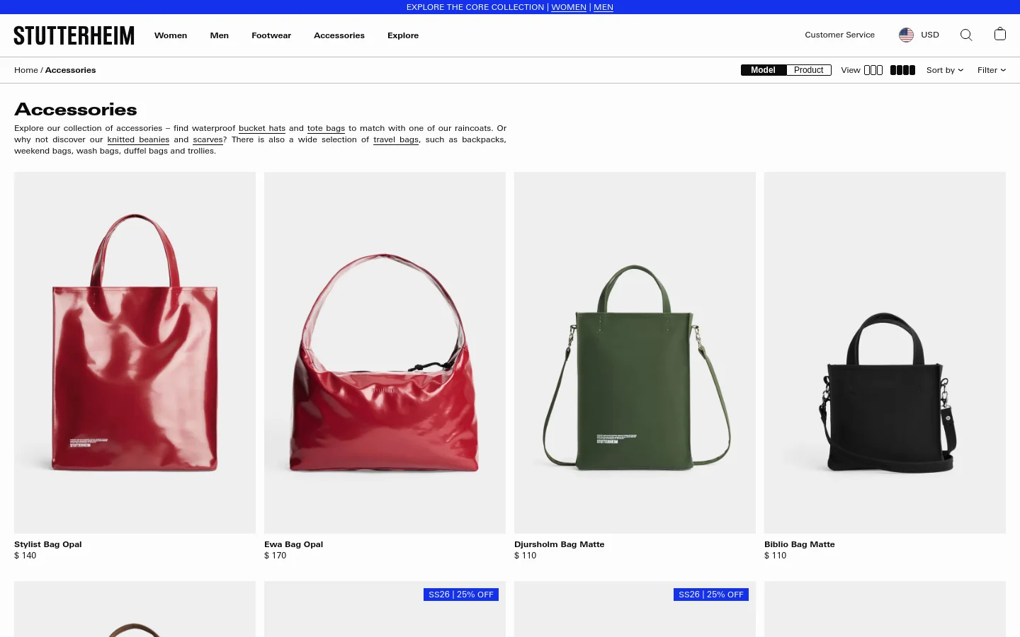 The desktop version of the Accessories page features a minimalist white layout with the Stutterheim logo at the top. A large heading reads 'Accessories' followed by a brief descriptive paragraph, above a grid of product images showing various colorful tote bags. Users can sort and filter products using options located at the top right of the product grid.