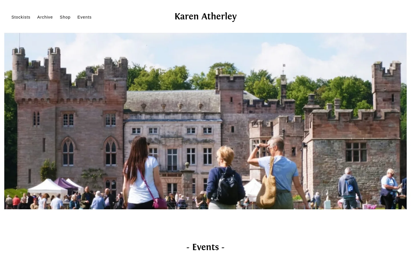 The desktop page features a wide hero image of a large stone castle with people gathered on a green lawn in the foreground. The website header displays the name 'Karen Atherley' in a serif font, centered above the image, with a navigation menu containing links for Stockists, Archive, Shop, and Events at the top left.