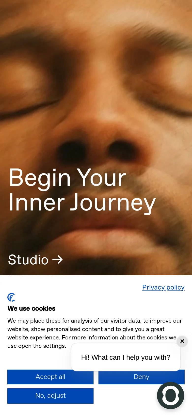 The mobile version presents a vertically stacked layout, beginning with a full-screen hero image of a person with closed eyes and the headline 'Begin Your Inner Journey'. Navigation links and text are centered, and the cookie consent banner appears as a large overlay at the bottom of the screen.
