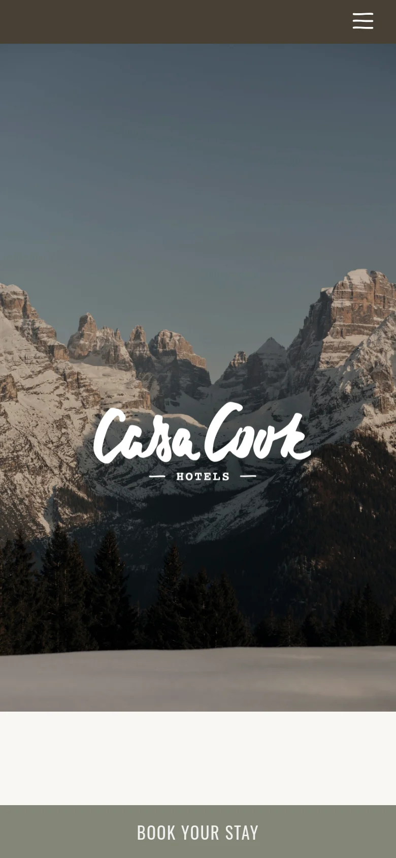 The mobile version displays a full-screen hero image of snow-capped mountains with the 'Casa Cook Hotels' logo overlaid. A hamburger menu icon is visible in the top right, and a prominent 'BOOK YOUR STAY' call-to-action button spans the bottom of the screen in a muted olive green.
