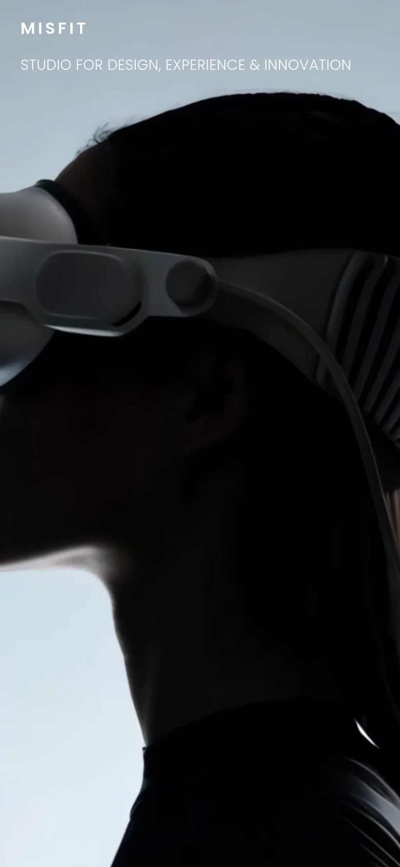 The mobile version maintains the same black-and-white aesthetic with the hand imagery, but the layout is vertically compressed. The 'MISFIT' logo and tagline are positioned higher up to accommodate the portrait orientation of the screen.