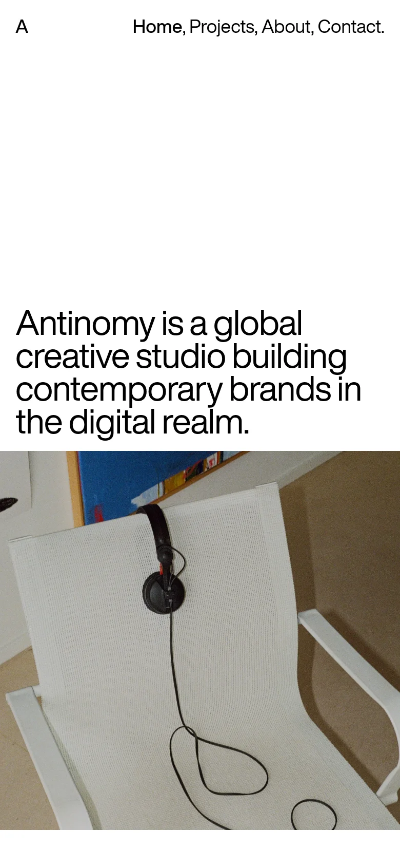 The mobile version maintains the minimalist aesthetic with a white background and bold black text. The layout is vertically stacked, showing the studio's headline prominently above a cropped view of the hero image featuring the white chair and headphones. The navigation links are condensed at the top for easier mobile access.
