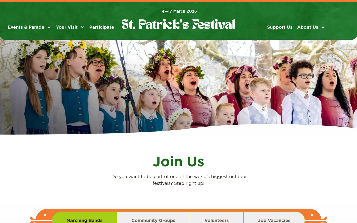 The desktop page features a green header with the St. Patrick's Festival logo and navigation menu, positioned above a large hero image of a choir wearing flower crowns. Below the image, a large 'Join Us' headline is followed by a subtext and a horizontal row of four navigation buttons: Marching Bands, Community Groups, Volunteers, and Job Vacancies.