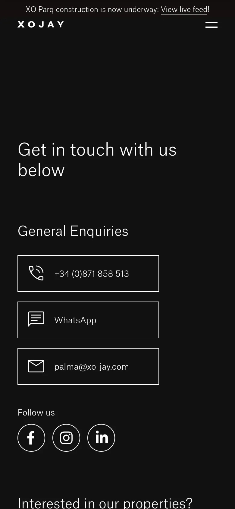 The mobile version maintains the dark aesthetic and white typography but uses a vertical single-column layout. The large hero headline is centered, and the contact buttons for phone, WhatsApp, and email are stacked vertically for easier tapping on a smaller screen.