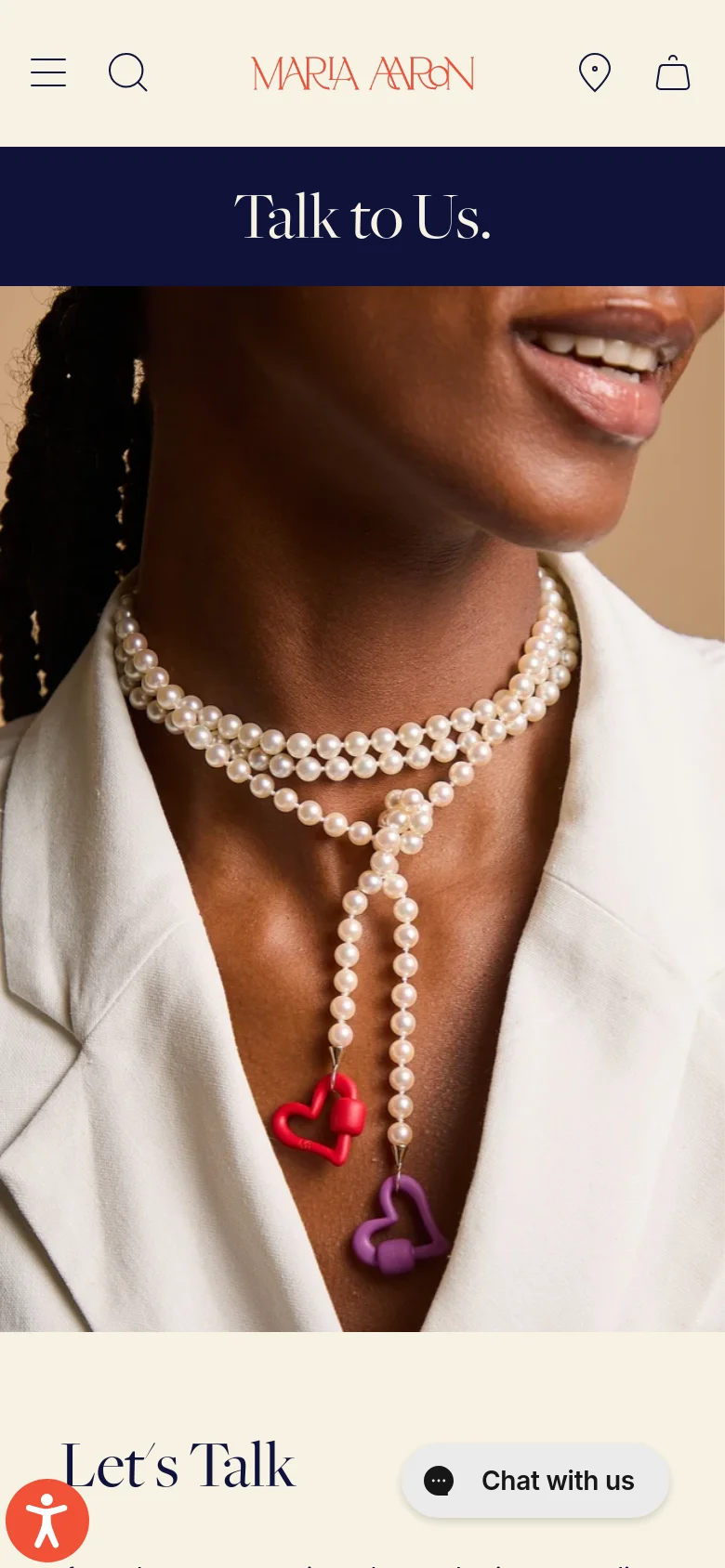 The mobile version uses a single-column layout, starting with a navy blue 'Talk to Us' banner followed by a full-width hero image of a person wearing pearl necklaces with heart charms. Below the image, the 'Let's Talk' text and contact details are stacked vertically, and a floating 'Chat with us' button is visible at the bottom right.