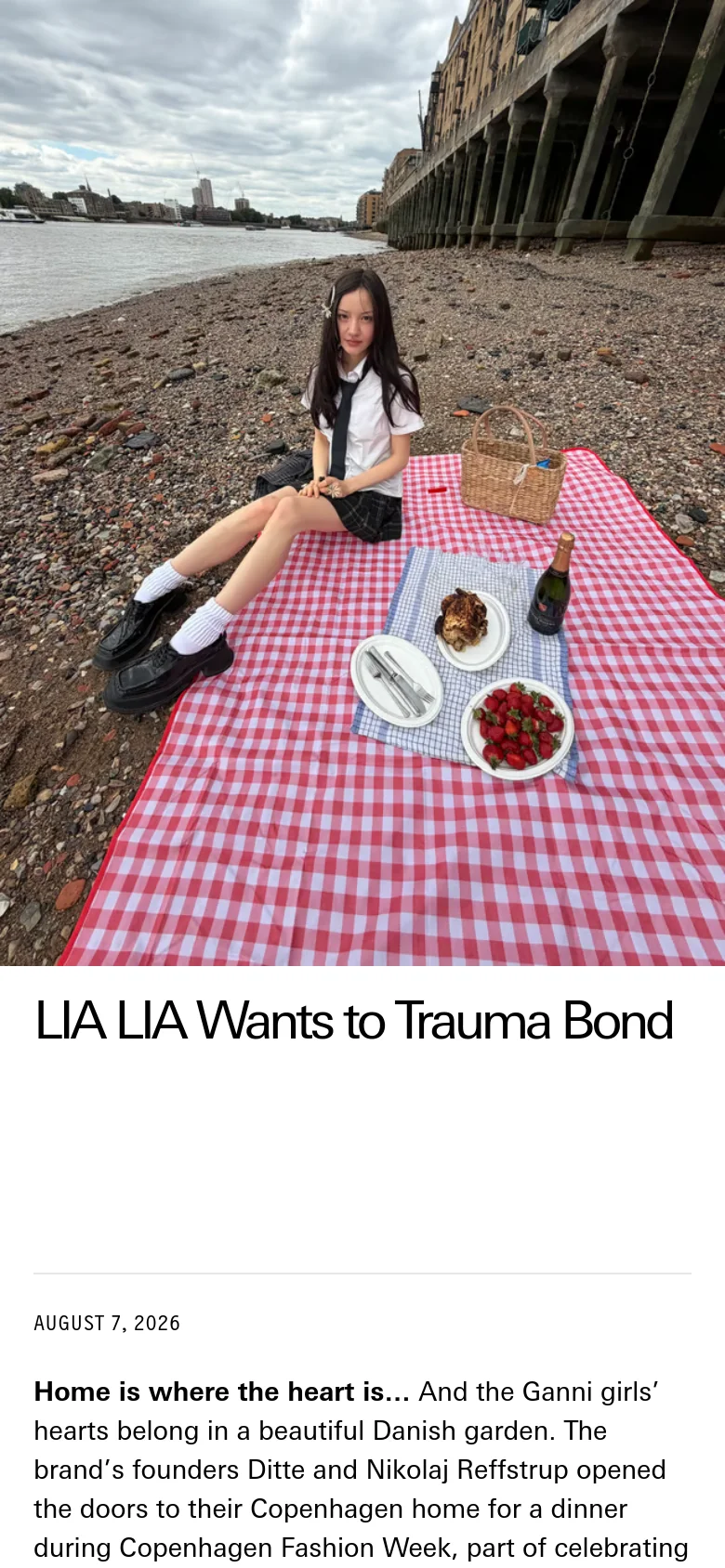 The mobile version presents a vertically stacked layout, starting with a large hero image of a person sitting on a red checkered picnic blanket on a beach. The headline 'LIA LIA Wants to Trauma Bond' and the article text follow below in a single-column format, optimized for vertical scrolling on a smaller screen.