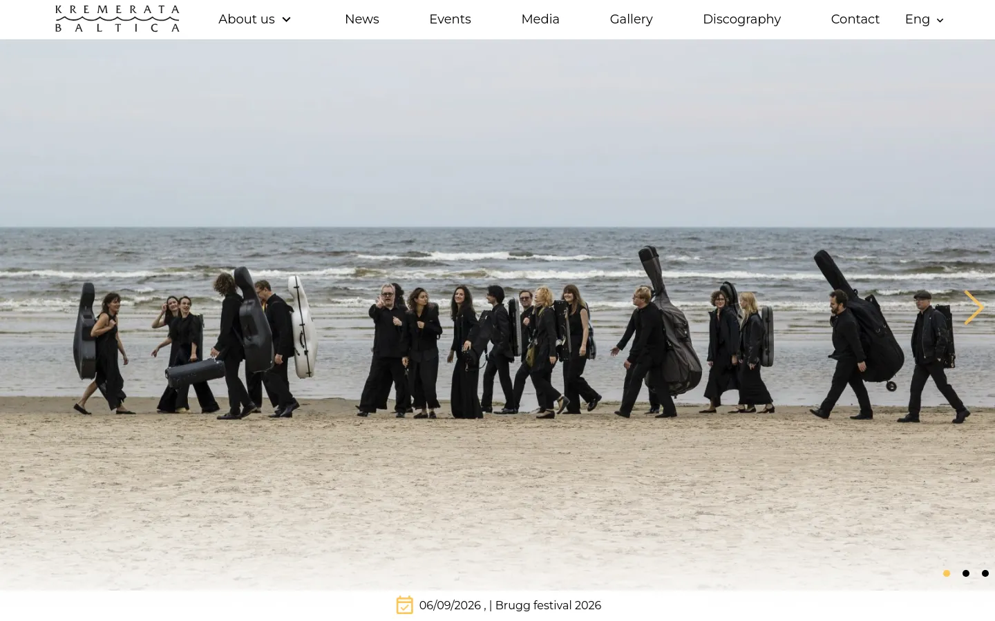 The desktop homepage features a large hero image slider showing orchestra members walking on a beach with instrument cases. A white navigation bar at the top includes the orchestra logo and links for About us, News, Events, Media, Gallery, Discography, and Contact. Below the hero image, a quote by Gidon Kremer is displayed above an introductory text section and an upcoming events grid.