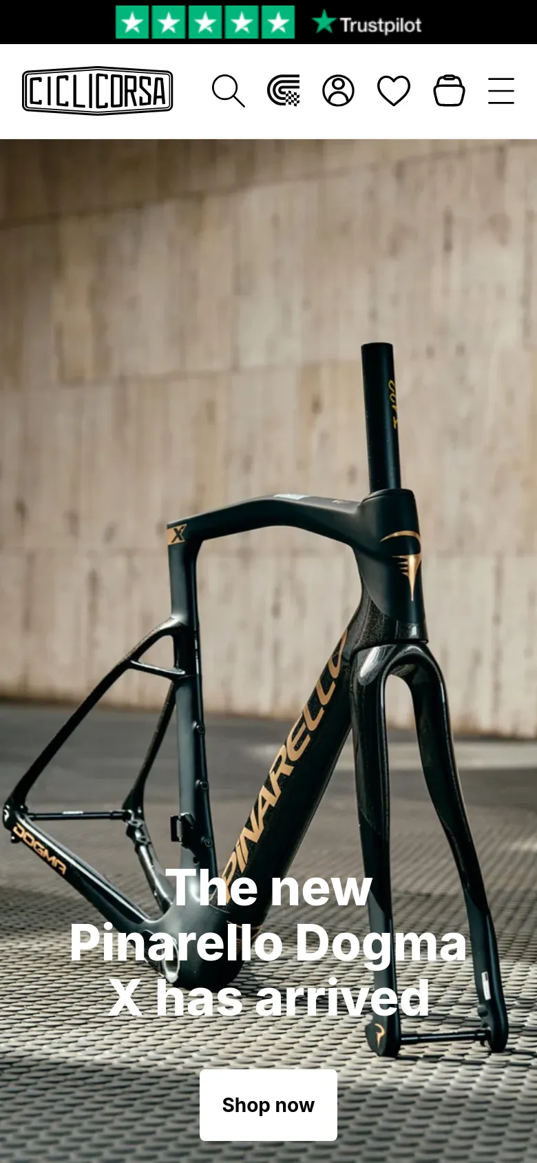 The mobile version displays a vertically oriented hero image of the Pinarello Dogma X bike frame. The headline and 'Shop now' button are centered over the image, and the navigation is condensed into a hamburger menu icon next to search, account, and cart icons at the top.