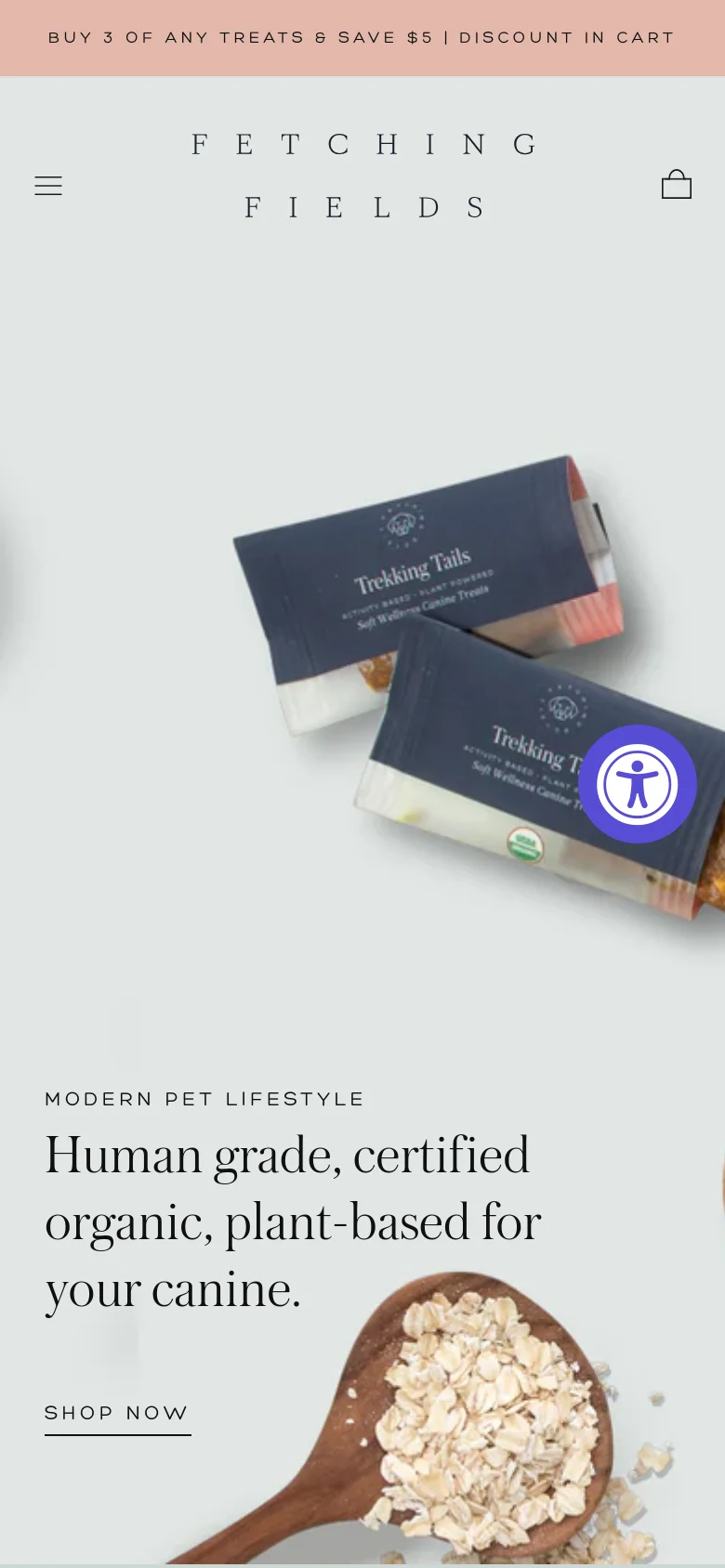 The mobile version uses a vertical layout with a centered logo and a hamburger menu icon for navigation. The hero section features a large image of dog treat bars amidst organic ingredients, followed by the main headline and a prominent 'Shop Now' button. The overall color palette remains a soft, natural sage green.