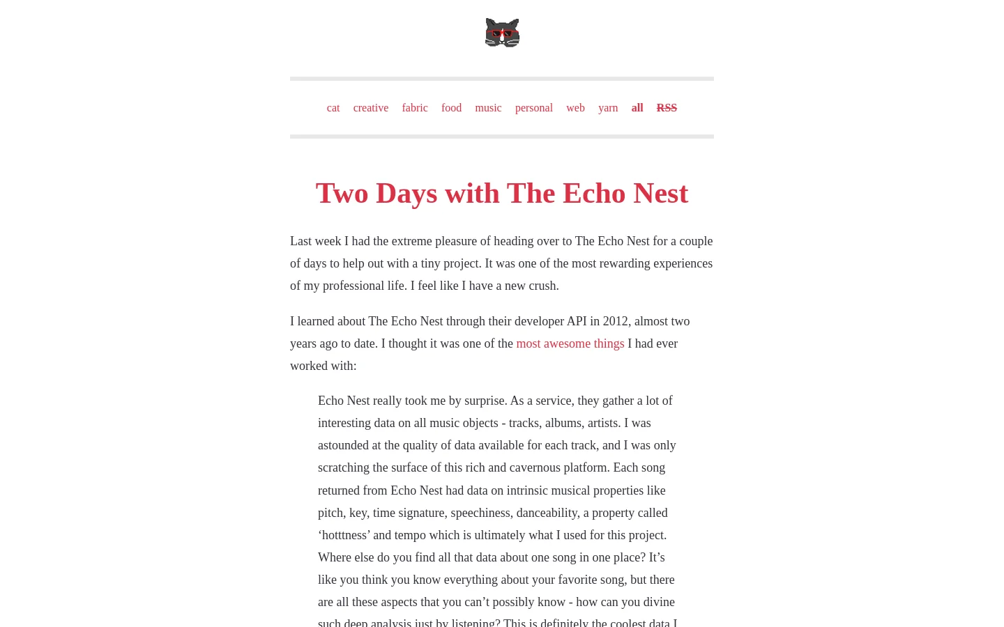 The blog page features a minimalist white background with a small cat icon at the top center. A horizontal list of red text category links sits above a large red headline, 'Two Days with The Echo Nest,' followed by several paragraphs of black text and a blockquote.