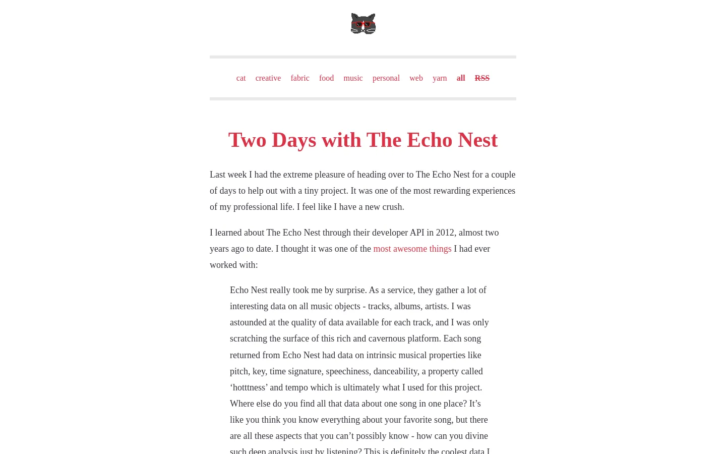 The blog page features a minimalist white background with a small cat icon at the top center. A horizontal list of red text category links sits above a large red headline, 'Two Days with The Echo Nest,' followed by several paragraphs of black text and a blockquote.