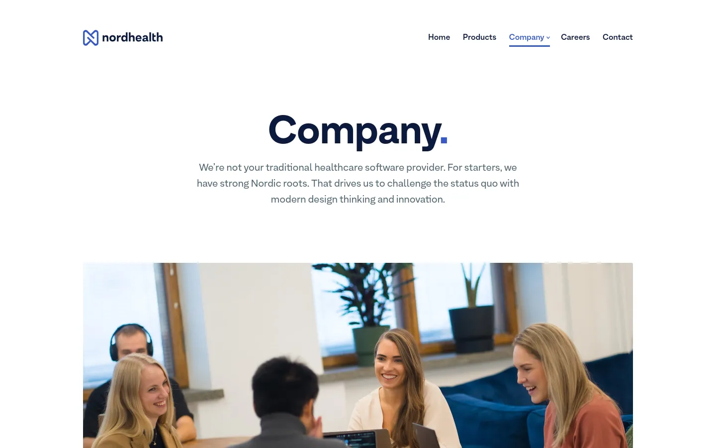 The desktop page features a clean, white layout with the Nordhealth logo and navigation menu at the top. A large 'Company' headline is centered above an introductory paragraph, followed by a wide hero image showing a group of diverse professionals collaborating in a bright, modern office setting.