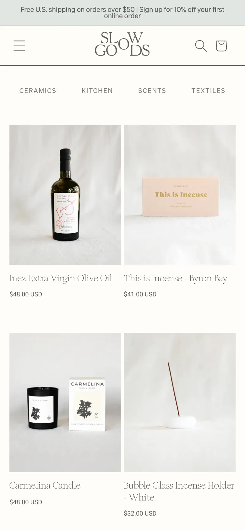 The mobile version maintains the minimalist aesthetic but uses a condensed layout with a hamburger menu and a search icon in the header. The product grid shifts to a single-column view, displaying large product images stacked vertically with titles and prices clearly legible underneath each item.