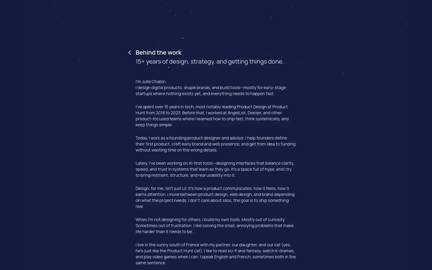 The desktop page features a dark navy background with a minimalist layout. A navigation menu is at the top left, followed by a large headline 'Behind the work' and a subheadline about 15+ years of design experience. The main content consists of several paragraphs of white text describing Julie Chabin's professional background and personal interests.