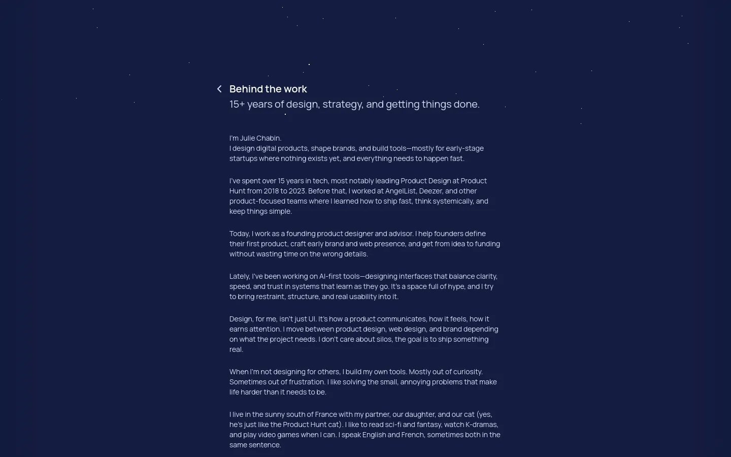 The desktop page features a dark navy background with a minimalist layout. A navigation menu is at the top left, followed by a large headline 'Behind the work' and a subheadline about 15+ years of design experience. The main content consists of several paragraphs of white text describing Julie Chabin's professional background and personal interests.